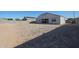 Spacious backyard featuring a gravel ground cover and a block wall, ready for landscaping at 30560 W Weldon Ave, Buckeye, AZ 85396