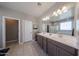 Bright bathroom with dual sinks, tile flooring, and white countertop at 30560 W Weldon Ave, Buckeye, AZ 85396
