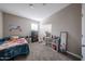 Neutral bedroom featuring a carpeted floor, storage cabinet, closet and brightly colored decorations at 30560 W Weldon Ave, Buckeye, AZ 85396