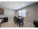 Dining area with wood table provides a comfortable spot for meals, enhanced by natural light at 30560 W Weldon Ave, Buckeye, AZ 85396