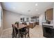 Dining area features a wood table set, adjacent to the kitchen, offering a cozy eating space at 30560 W Weldon Ave, Buckeye, AZ 85396