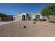 Attractive single-story home with a two-car garage and a low-water desert rock front yard at 30560 W Weldon Ave, Buckeye, AZ 85396