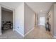 Hallway features tiled floors, neutral paint, and access to other rooms in the home at 30560 W Weldon Ave, Buckeye, AZ 85396