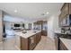 Spacious kitchen with island overlooking the living room creates an inviting open floor plan at 30560 W Weldon Ave, Buckeye, AZ 85396