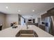 Kitchen island with sink and stainless steel appliances overlooking the open living area at 30560 W Weldon Ave, Buckeye, AZ 85396