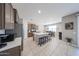 Open-concept kitchen boasts an island with bar seating, stainless steel appliances, and a dining area at 30560 W Weldon Ave, Buckeye, AZ 85396