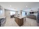 Open kitchen and living area is perfect for entertaining, featuring modern appliances and ample space at 30560 W Weldon Ave, Buckeye, AZ 85396