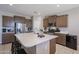 Bright kitchen with island, stainless steel appliances, and plenty of cabinet space for storage at 30560 W Weldon Ave, Buckeye, AZ 85396