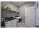 Organized laundry room features a modern washer and dryer set, as well as storage shelves at 30560 W Weldon Ave, Buckeye, AZ 85396