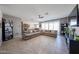 Open living room with tile flooring, a ceiling fan, and sliding doors to the backyard at 30560 W Weldon Ave, Buckeye, AZ 85396