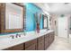 Bathroom featuring a blue accent wall, long vanity, and decorative wall accents at 31156 N 137Th Ln, Peoria, AZ 85383