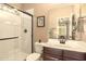 Bathroom featuring a shower, toilet, and a vanity with a wood cabinet at 31156 N 137Th Ln, Peoria, AZ 85383