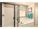 Bathroom with a glass-enclosed shower and a separate soaking tub at 31156 N 137Th Ln, Peoria, AZ 85383