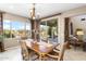 Bright dining room with patio access and views of the backyard and living space at 31156 N 137Th Ln, Peoria, AZ 85383