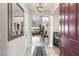Inviting entryway featuring tile flooring, a decorative mirror, and views into the living room at 31156 N 137Th Ln, Peoria, AZ 85383