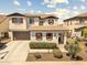 Two-story home featuring brown accents, red shutters, and a two-car garage at 31156 N 137Th Ln, Peoria, AZ 85383