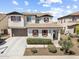 Charming two-story home featuring desert landscaping, a two-car garage, and red window shutters at 31156 N 137Th Ln, Peoria, AZ 85383