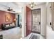 Bright foyer with an open door reveals a spacious living room, creating a warm welcome at 31156 N 137Th Ln, Peoria, AZ 85383