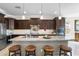 Modern kitchen features an island with seating, granite countertops, and stainless steel appliances at 31156 N 137Th Ln, Peoria, AZ 85383