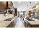 Modern kitchen boasts stainless steel appliances, granite countertops, and an open view to the dining area at 31156 N 137Th Ln, Peoria, AZ 85383