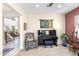 Sitting room with a piano, chair, rug, and decor for a welcoming ambiance at 31156 N 137Th Ln, Peoria, AZ 85383