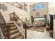 Open-concept living room with soaring ceilings, staircase, and ample natural light at 31156 N 137Th Ln, Peoria, AZ 85383