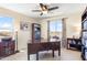 Comfortable office with a large wooden desk, bookcase, and a window view of the neighborhood at 31156 N 137Th Ln, Peoria, AZ 85383
