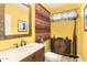 Powder room with yellow walls, decorative accents, and a marble countertop at 31156 N 137Th Ln, Peoria, AZ 85383
