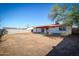 View of the spacious backyard with a mature tree and a block wall surrounding the property at 3209 W Charleston Ave, Phoenix, AZ 85053