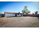 Spacious backyard with patio, block wall, and a mature tree, perfect for outdoor activities at 3209 W Charleston Ave, Phoenix, AZ 85053