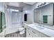 Well-lit bathroom with tub-shower, vanity with modern sink and hardware, and wood-look flooring at 3209 W Charleston Ave, Phoenix, AZ 85053