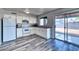 Functional kitchen with white appliances, modern plank flooring, and a sliding glass door to the backyard at 3209 W Charleston Ave, Phoenix, AZ 85053
