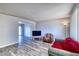 Bright living room with plank flooring and neutral wall paint and lots of light at 3209 W Charleston Ave, Phoenix, AZ 85053