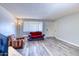 Inviting living area with plank flooring, neutral paint and large windows allowing for ample light at 3209 W Charleston Ave, Phoenix, AZ 85053