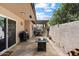 Cozy covered patio with fire pit, seating, and grill, perfect for outdoor entertaining at 3345 E University Dr # 72, Mesa, AZ 85213