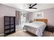 Bright bedroom has a ceiling fan and large window for natural light, plus neutral carpet at 3345 E University Dr # 72, Mesa, AZ 85213