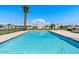 Large community pool with clear blue water, palm trees, and plenty of space for lounging at 3345 E University Dr # 72, Mesa, AZ 85213