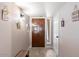 Charming foyer featuring a stained wood front door, tile flooring and decorative wall hangings at 3345 E University Dr # 72, Mesa, AZ 85213