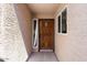 Inviting front entrance featuring a stained wood door with sidelight and stylish exterior texture at 3345 E University Dr # 72, Mesa, AZ 85213