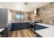 Stylish kitchen with brick accent wall, modern appliances, and ample counter space at 3345 E University Dr # 72, Mesa, AZ 85213