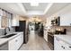 Bright kitchen features white cabinets, stainless steel appliances, and an open layout into the dining area at 3345 E University Dr # 72, Mesa, AZ 85213