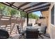 Relaxing patio features a dining set, grill, fire pit, and a charming pergola at 3345 E University Dr # 72, Mesa, AZ 85213