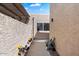 View of the stucco walkway on the side of the house, lined with plants and flowers at 3345 E University Dr # 72, Mesa, AZ 85213