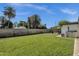 Expansive backyard with lush lawn and privacy fence, featuring a partially covered patio at 3711 S Judd St, Tempe, AZ 85282