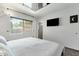 Bright bedroom featuring a mirrored ceiling, mounted tv and window letting in natural light at 3711 S Judd St, Tempe, AZ 85282