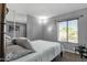 Cozy bedroom with mirrored closet doors and natural light from the window at 3711 S Judd St, Tempe, AZ 85282