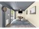 Bonus room features a mounted TV, stylish decor, and outdoor access at 3711 S Judd St, Tempe, AZ 85282