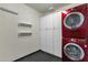Convenient laundry room featuring modern, stacked washer and dryer, plus storage cabinets at 3711 S Judd St, Tempe, AZ 85282