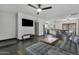Open-concept living area with a cozy sofa, a modern entertainment center, and adjoining dining space at 3711 S Judd St, Tempe, AZ 85282
