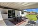 Cozy covered patio with dining set, perfect for outdoor meals and relaxation near sliding glass door at 3711 S Judd St, Tempe, AZ 85282